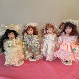 Set of four Porcelain Dolls w/ stands